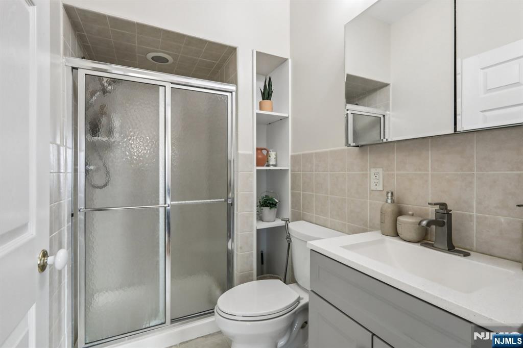 28 George Street Saddle Brook, NJ 07663 - Photo 38 of 50 a bathroom with a shower a toilet and a sink