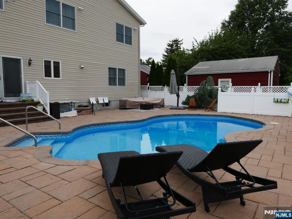 28 George Street Saddle Brook, NJ 07663 - Photo 46 of 50 a view of a patio with table and chairs with wooden floor and fence
