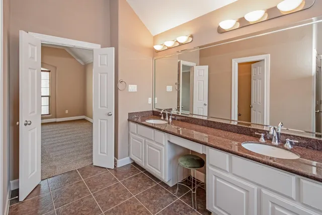 a bathroom with a double vanity sink and a mirror