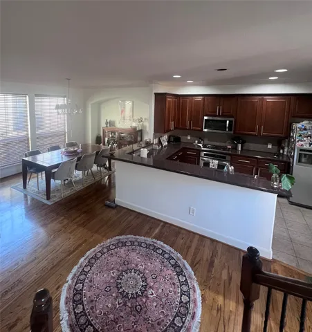 a kitchen with stainless steel appliances kitchen island granite countertop a sink and cabinets
