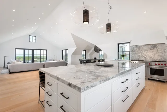 a kitchen with stainless steel appliances kitchen island granite countertop a stove and a sink
