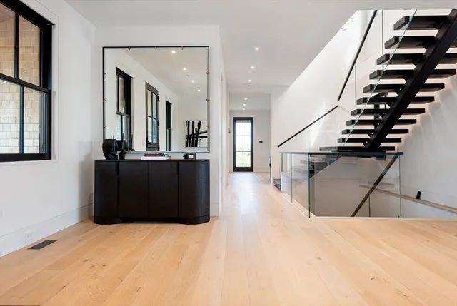 a view of a living room with furniture and stairs