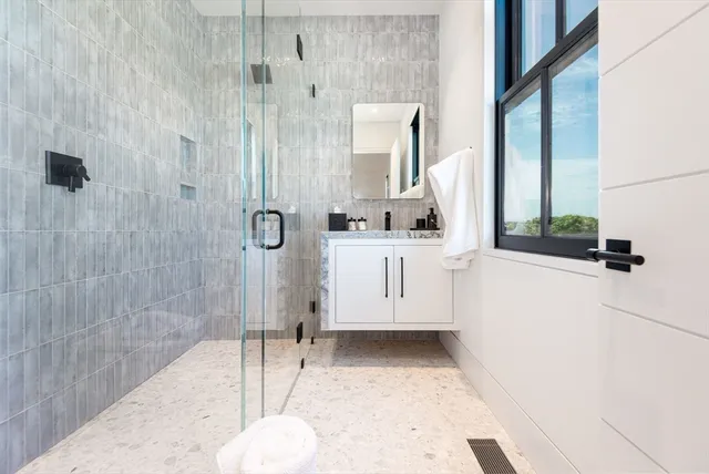 a bathroom with a sink a toilet and shower