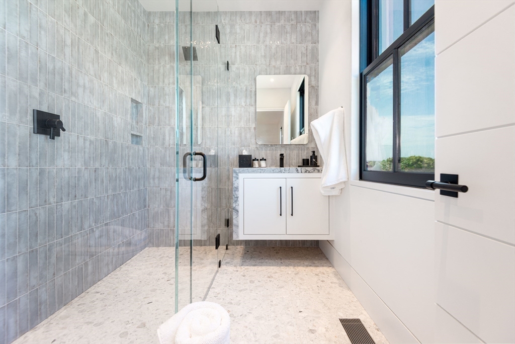 30 Devon Street, Unit THE BIG DIP Nantucket, MA 02554 - Photo 22 of 41 a bathroom with a sink a toilet and shower