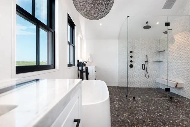 a bathroom with a bathtub and a shower