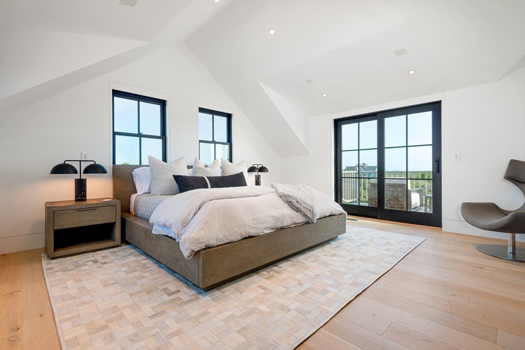 30 Devon Street, Unit THE BIG DIP Nantucket, MA 02554 - Photo 35 of 41 a spacious bedroom with a bed and glass window