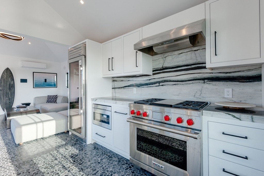 30 Devon Street, Unit THE BIG DIP Nantucket, MA 02554 - Photo 5 of 41 a kitchen with a stove and a microwave