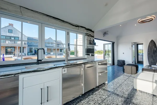 a large kitchen with granite countertop a large window and a sink