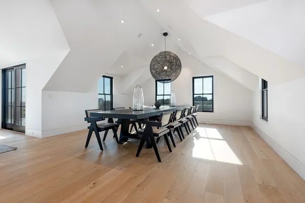 a view of a dining room and livingroom with furniture window and wooden floor