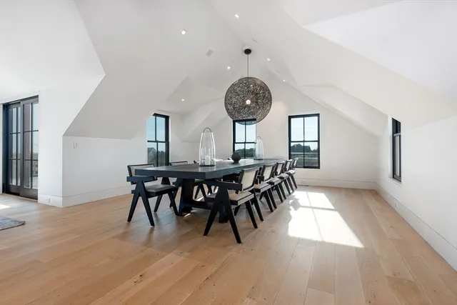 a view of a dining room and livingroom with furniture window and wooden floor