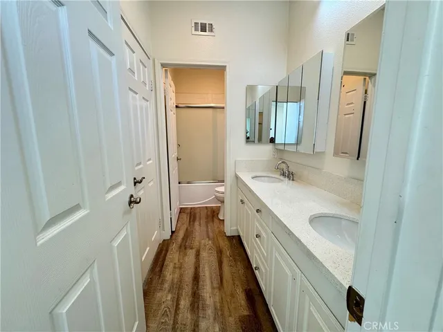 a bathroom with a sink a mirror and a shower