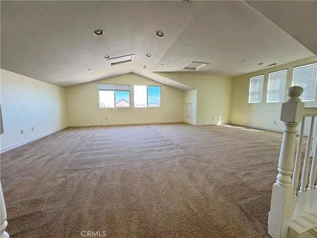 an empty room with windows and entrance