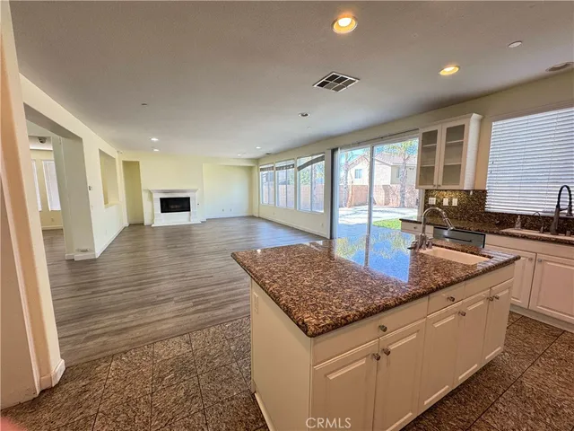 a kitchen with granite countertop wooden cabinets and a counter top space