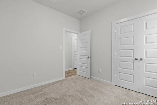 an empty room with walk in closet