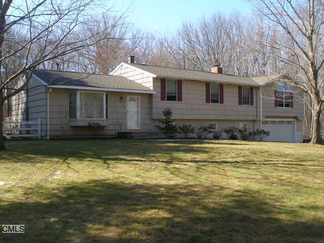 a front view of a house with a large pool