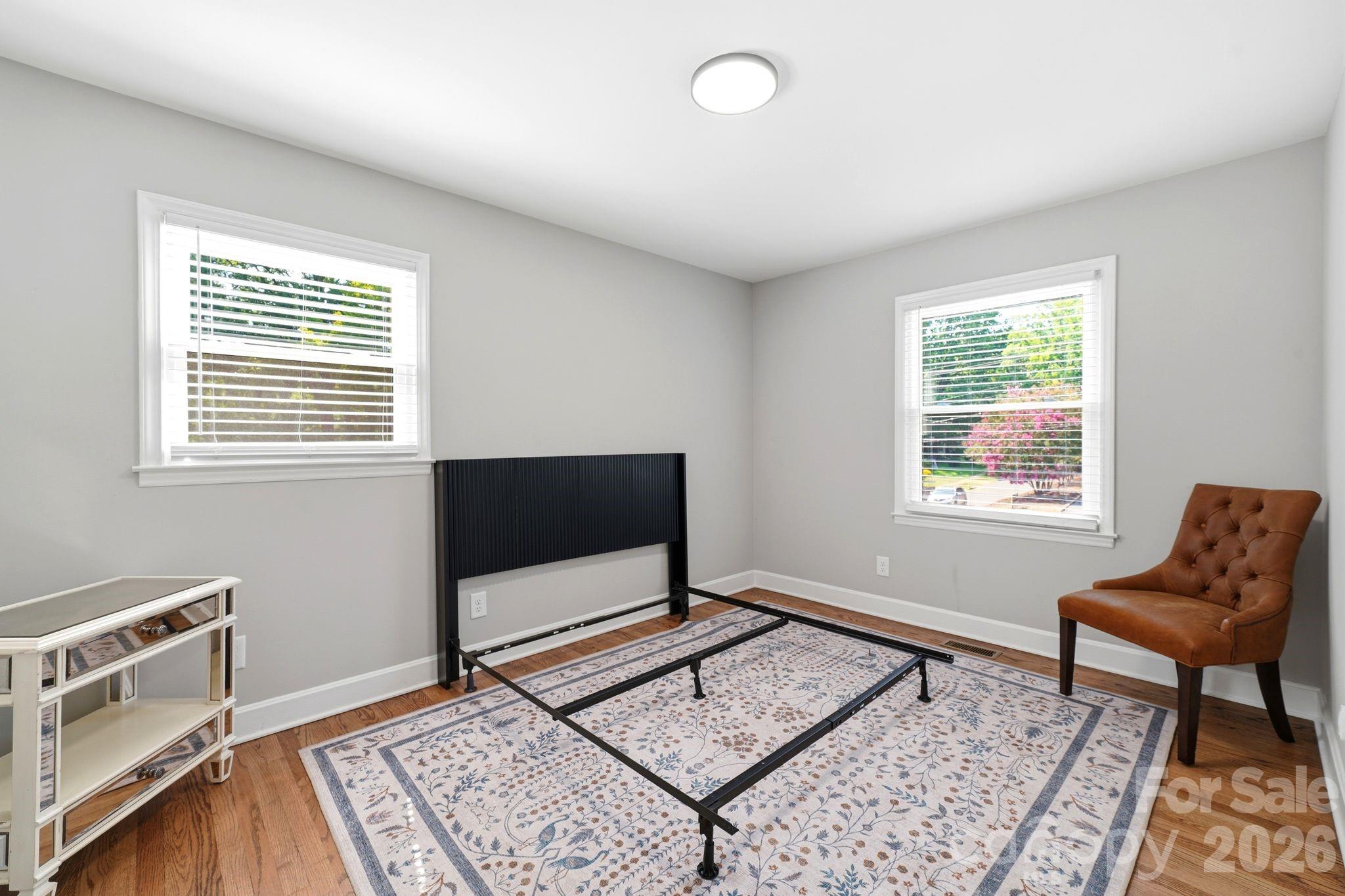 7552 Idlewild Road Charlotte, NC 28212 - Photo 13 of 40 a living room with a piano and a window