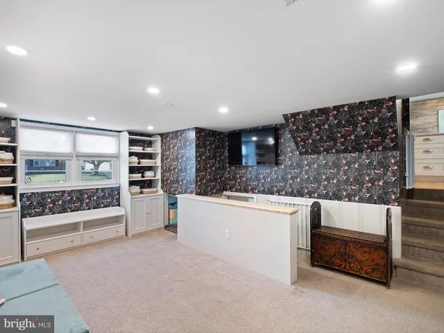 a kitchen with stainless steel appliances kitchen island granite countertop a refrigerator and a stove top oven