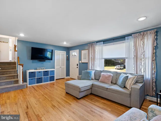 a spacious bedroom with a bed and a flat screen television