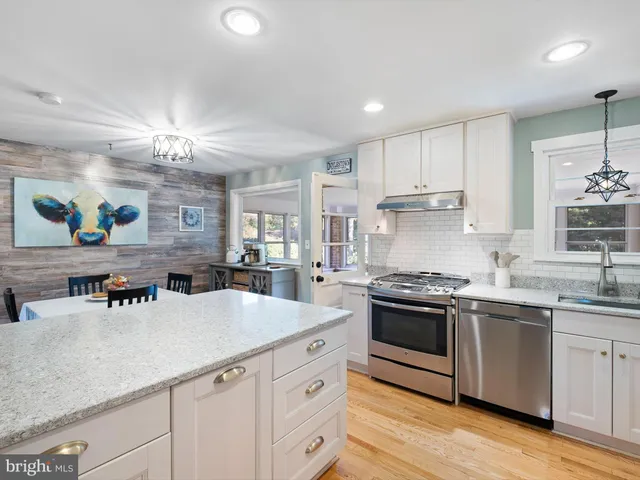 a kitchen with a sink stainless steel appliances and cabinets