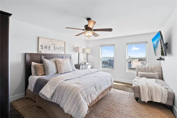a bedroom with a large bed and a chandelier