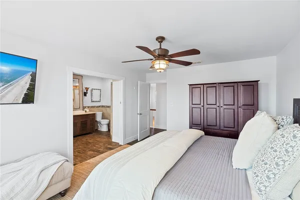a bedroom with a bed and a mirror