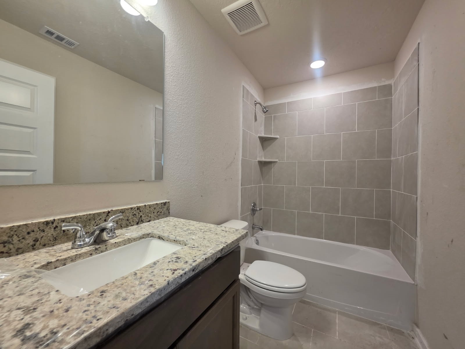 1498 Lk Rdg Drive Brenham, TX 77833 - Photo 12 of 14 a bathroom with a granite countertop sink toilet and shower