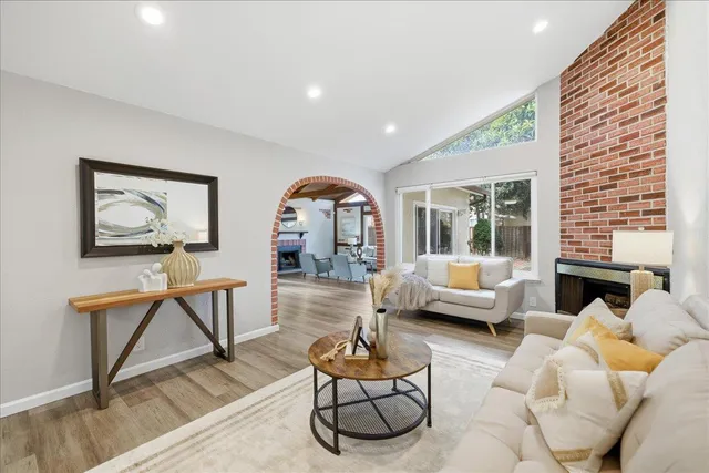 a living room with furniture a rug and a large window