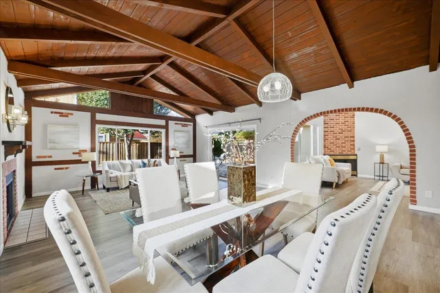 a living room with furniture a clock and a large window