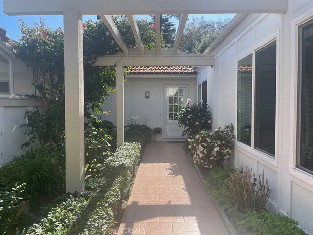 a view of a house with potted plants