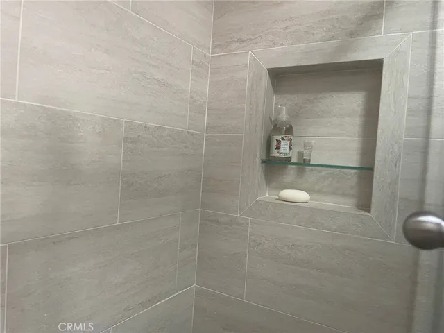 a bathroom with a glass shower door