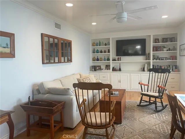 a living room with furniture a flat screen tv and rug