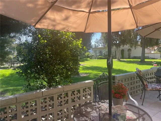 a view of a patio with a table & chairs