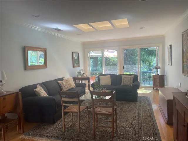 a living room with furniture and a floor to ceiling window