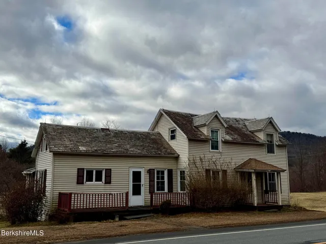 a view of a big house in a big yard with plants