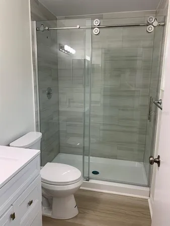 a bathroom with a toilet and shower