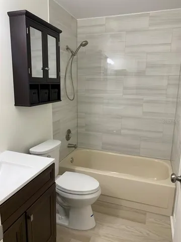 a bathroom with a toilet a sink and bathtub