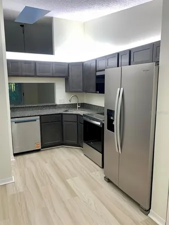 a kitchen with stainless steel appliances a refrigerator and a sink
