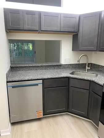 a kitchen with granite countertop cabinets