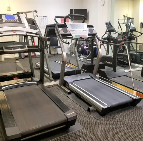 a room with gym equipment and a flat screen tv