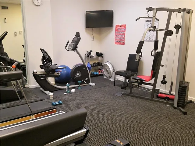 a living room with furniture a flat screen tv and large window