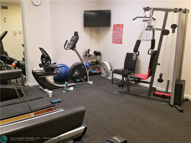 a living room with furniture a bookshelf and a book shelf