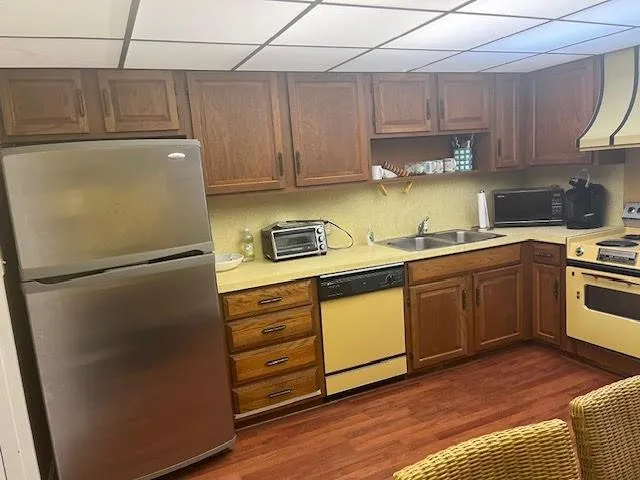 a kitchen with a refrigerator sink and cabinets