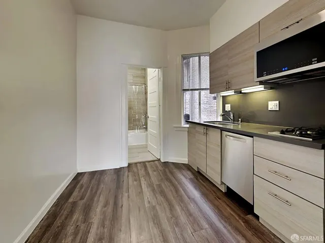 a kitchen with a sink and microwave