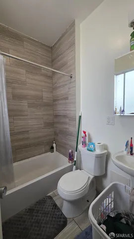 a bathroom with a toilet and a bathtub