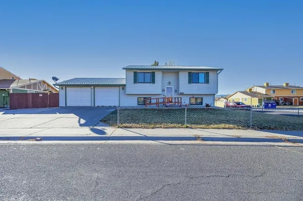 a view of house with outdoor space and parking