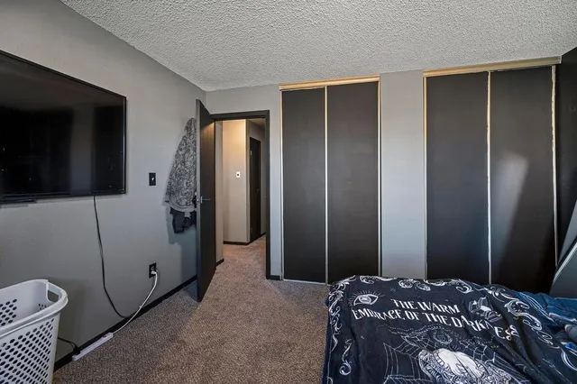 a bedroom with a bed and a mirror