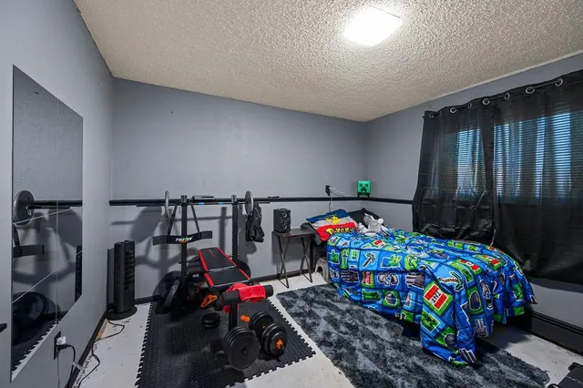 a bedroom with bunk bed and a small kitchen