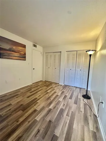 a view of a room with wooden floor