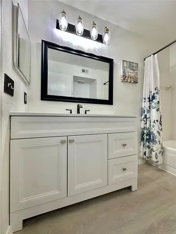 a utility room with white cabinets