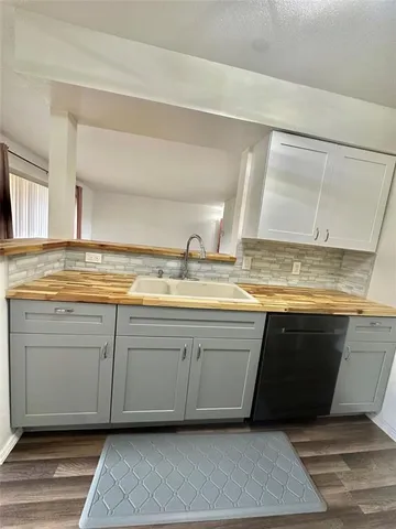 a view of a kitchen sink and microwave